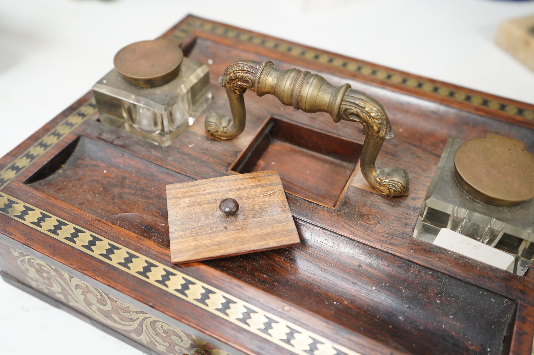 A George IV rosewood and cut brass inlaid two desk top inkstand, 29cm wide x 22cm deep